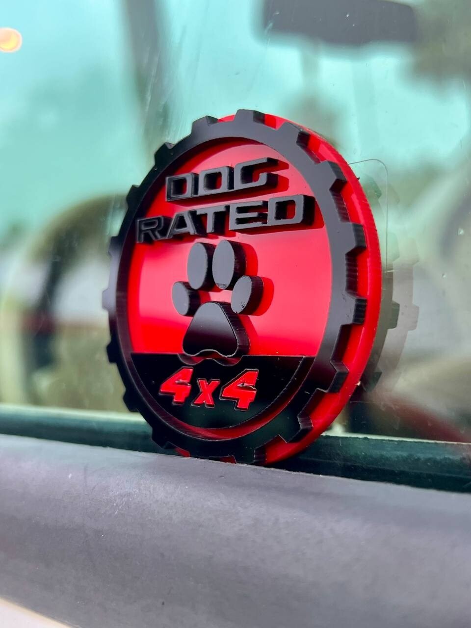 Red 4x4 acrylic badge mounted on a Jeep body pillar (hi-res)
