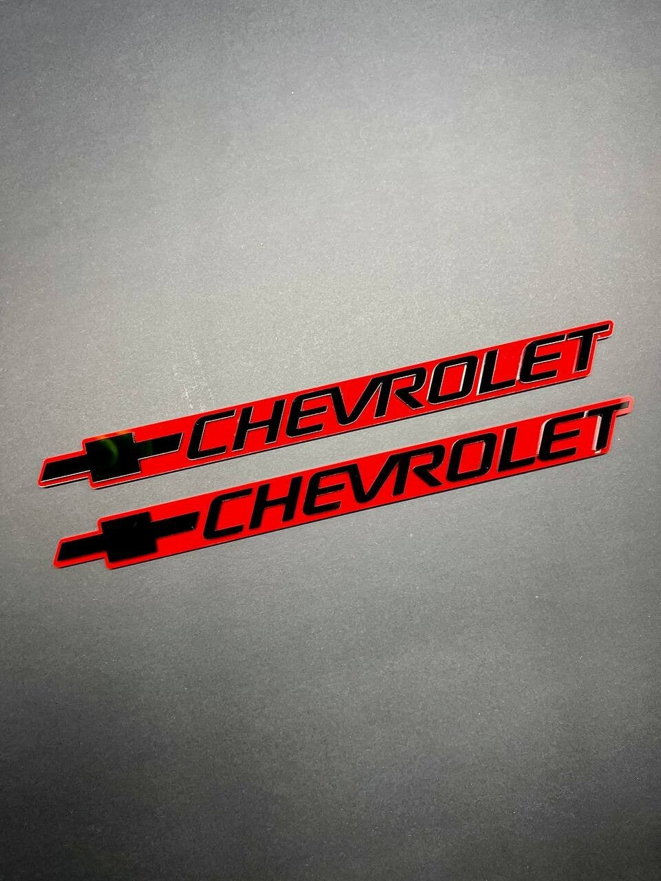 2PCS Black CHEVROLET Emblem Badges on Red Background – Aggressive 3D Styling