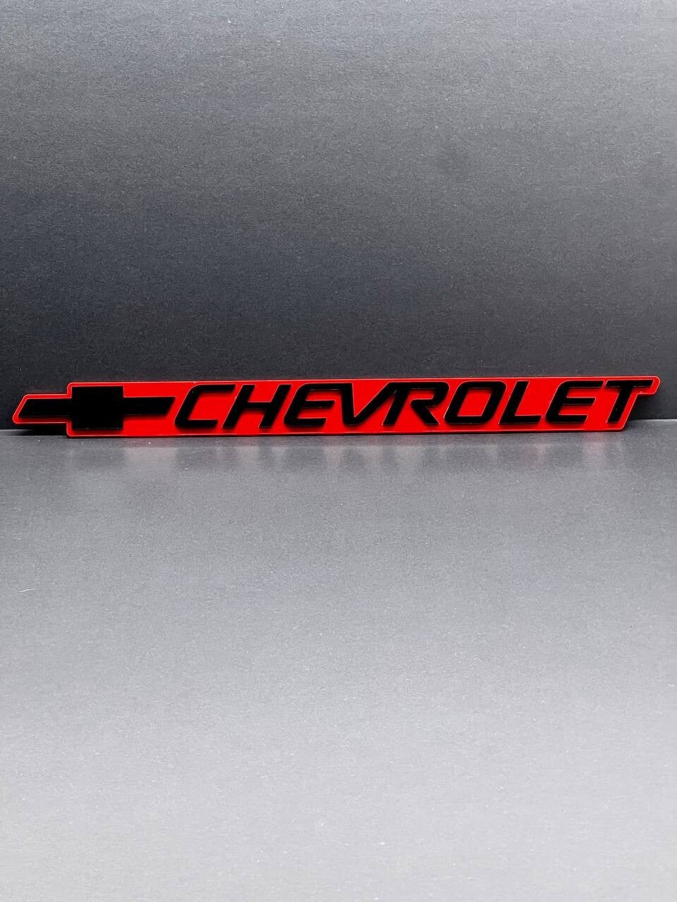 2PCS Black CHEVROLET Emblem Badges on Red Background – Aggressive 3D Styling