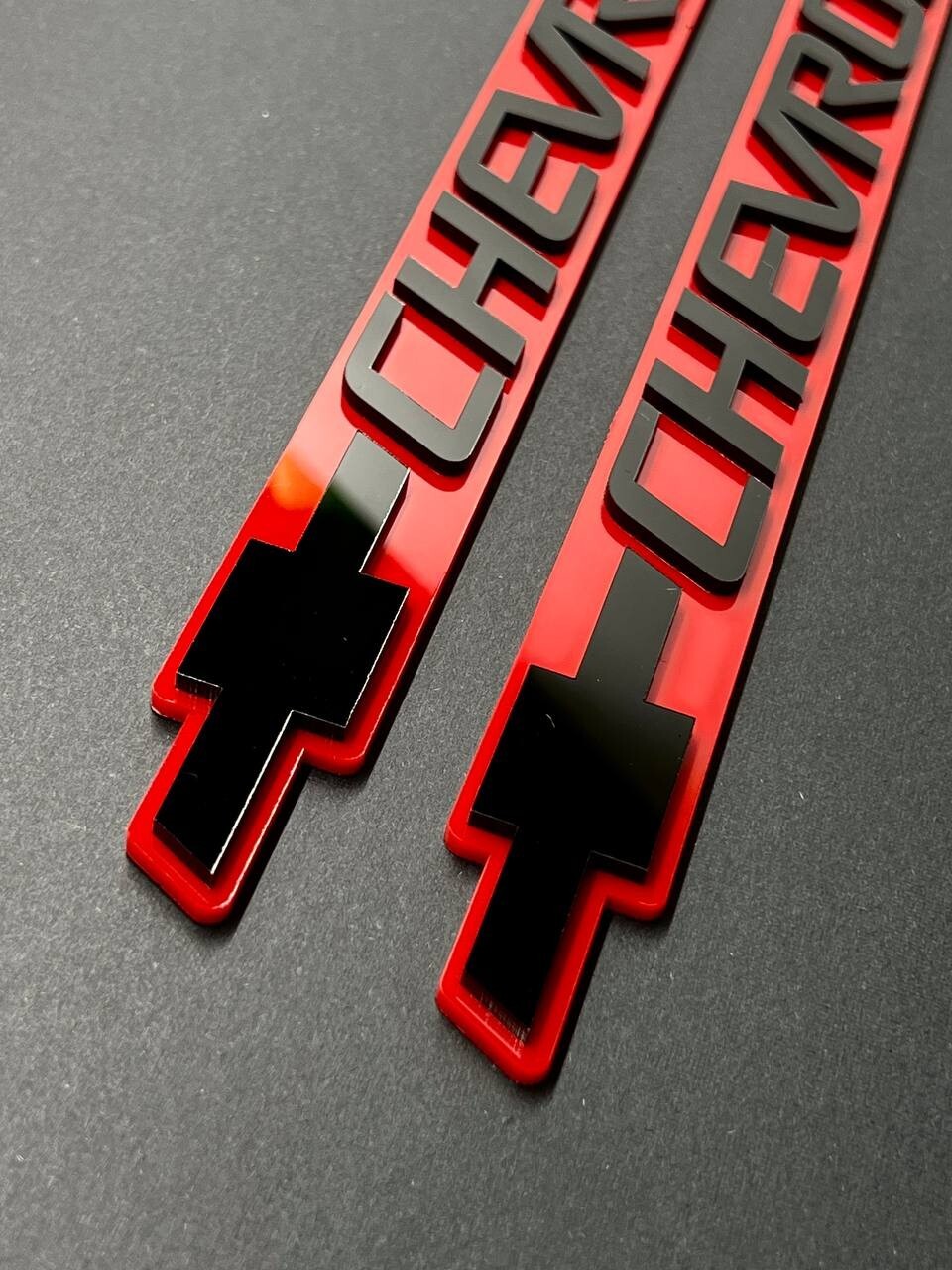 2PCS Black CHEVROLET Emblem Badges on Red Background – Aggressive 3D Styling