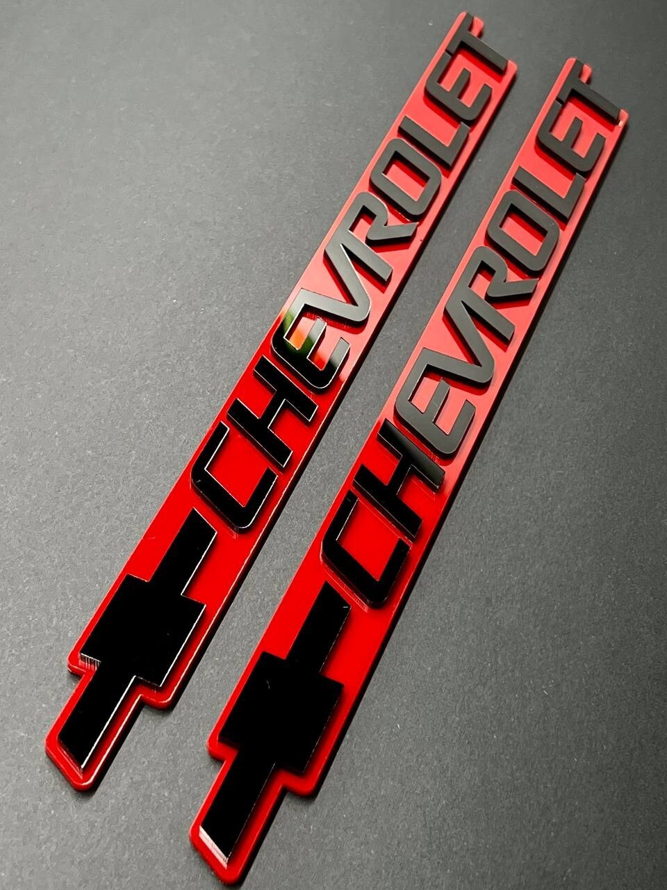 2PCS Black CHEVROLET Emblem Badges on Red Background – Aggressive 3D Styling