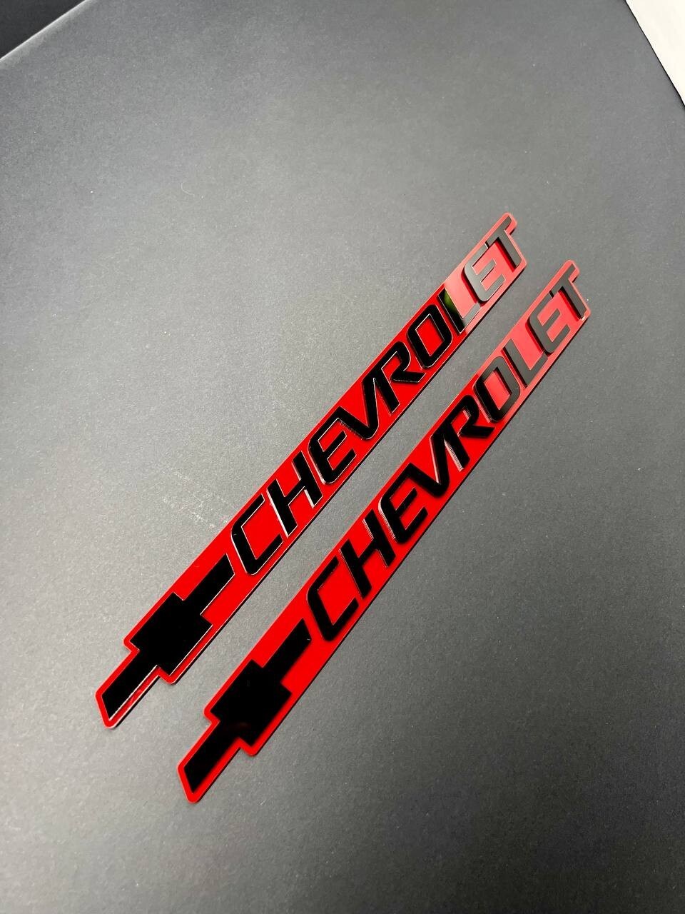 2PCS Black CHEVROLET Emblem Badges on Red Background – Aggressive 3D Styling