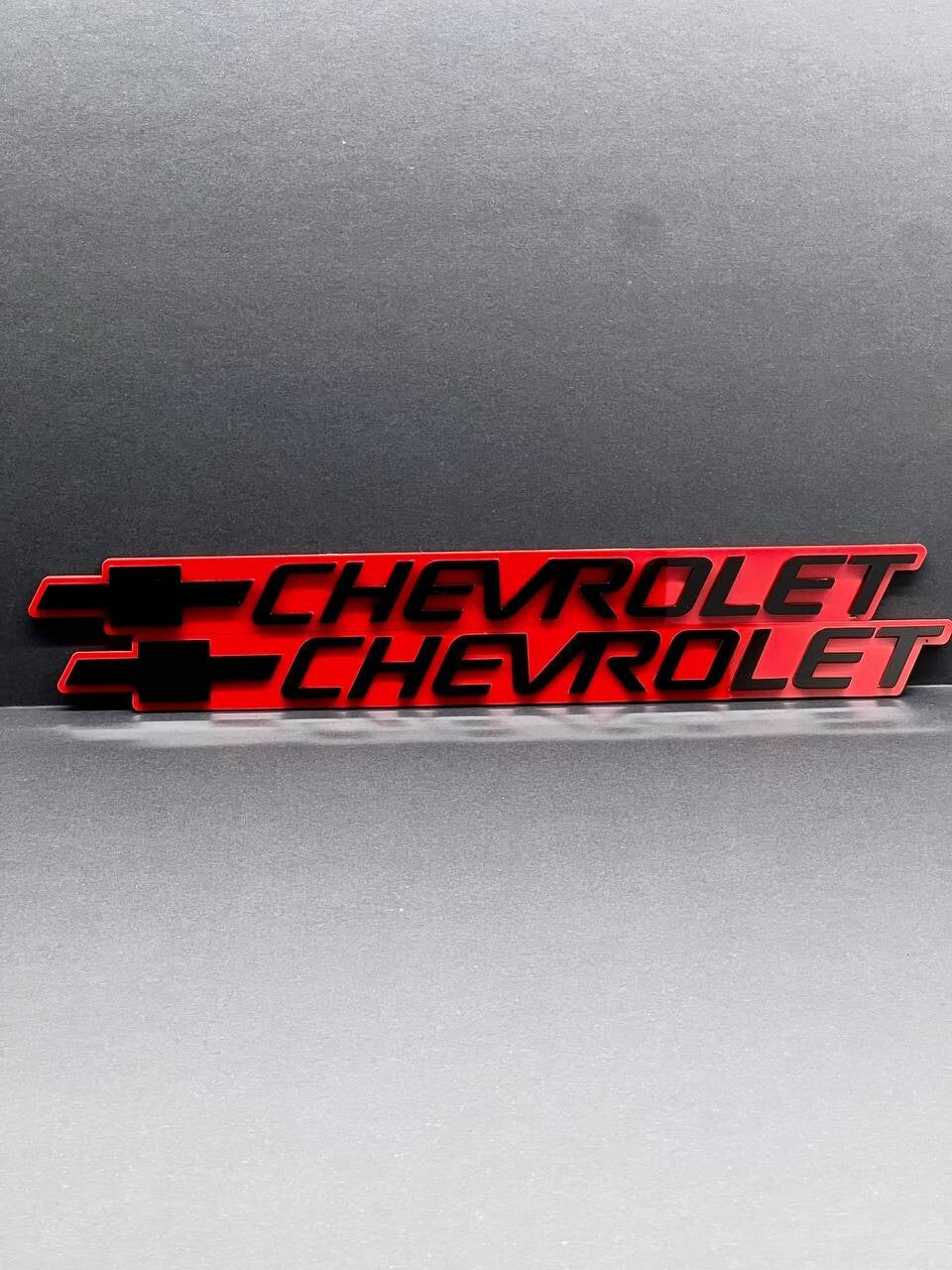 2PCS Black CHEVROLET Emblem Badges on Red Background – Aggressive 3D Styling