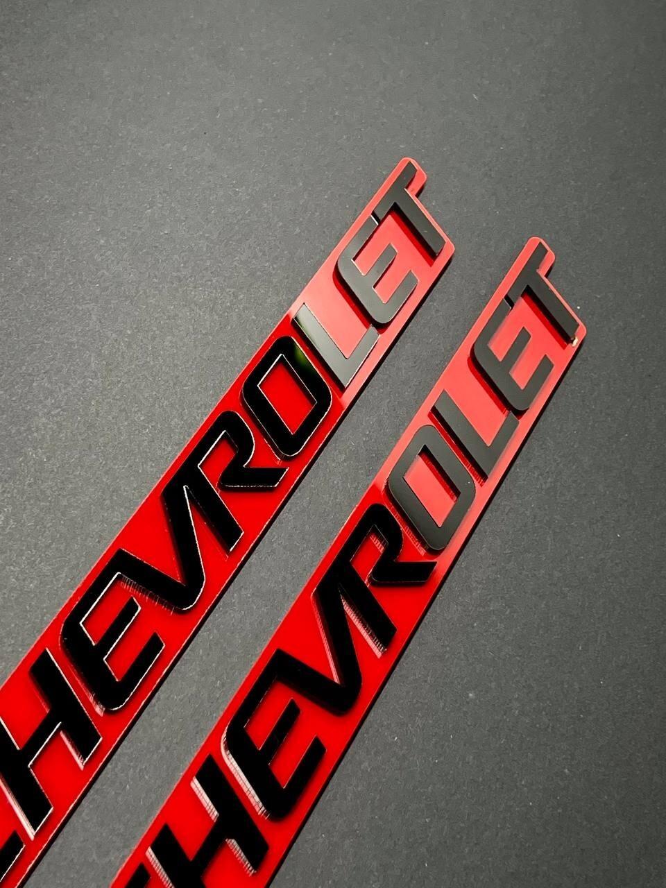 2PCS Black CHEVROLET Emblem Badges on Red Background – Aggressive 3D Styling