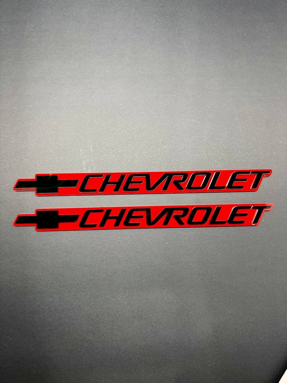 2PCS Black CHEVROLET Emblem Badges on Red Background – Aggressive 3D Styling