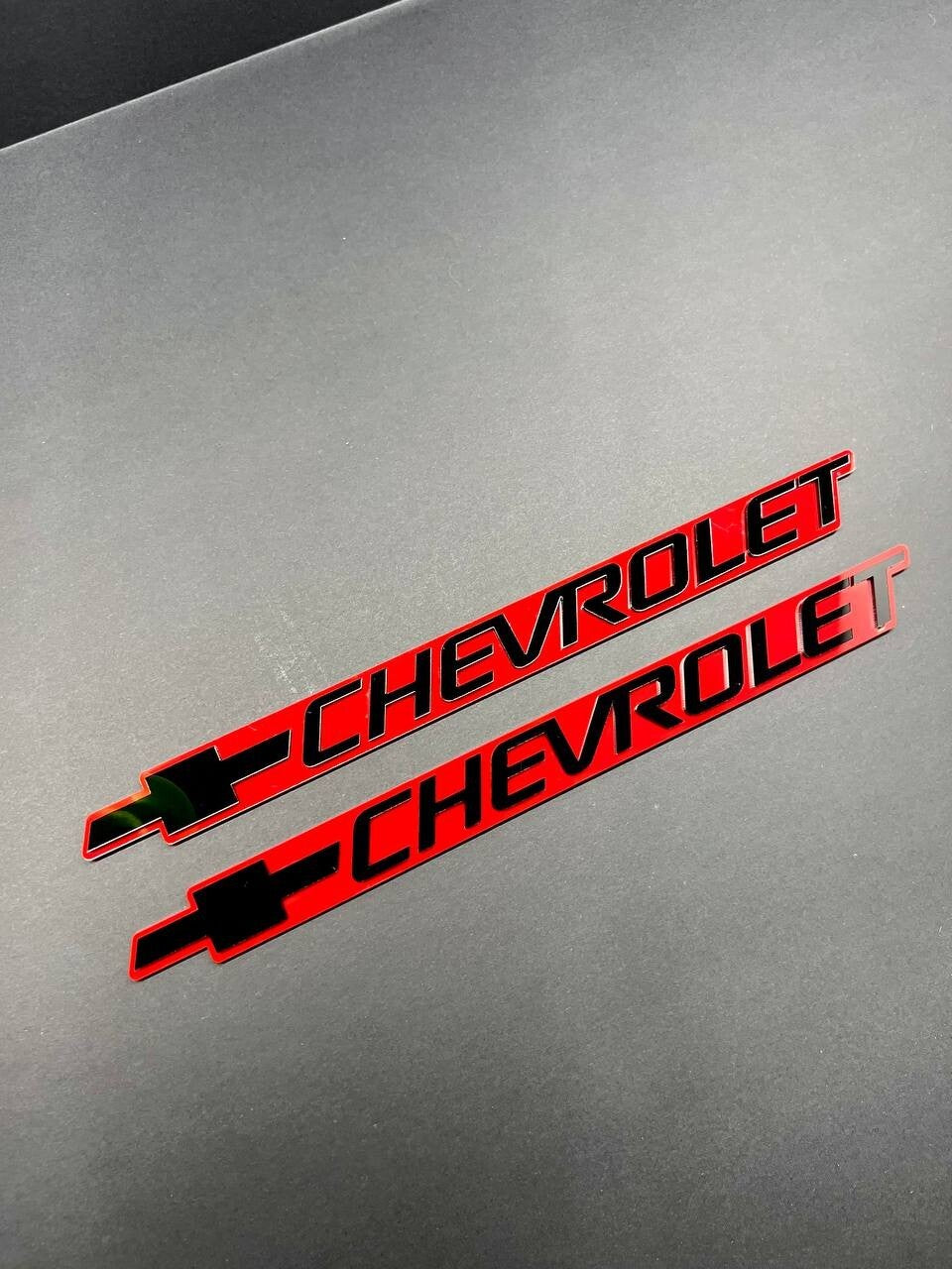 2PCS Black CHEVROLET Emblem Badges on Red Background – Aggressive 3D Styling