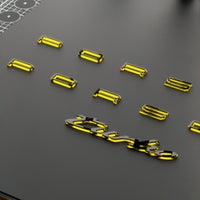 Porsche model characters cut in mirror acrylic, arranged on a black surface