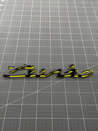 Mirror gold edge of the Porsche turbo acrylic emblem seen from a low angle