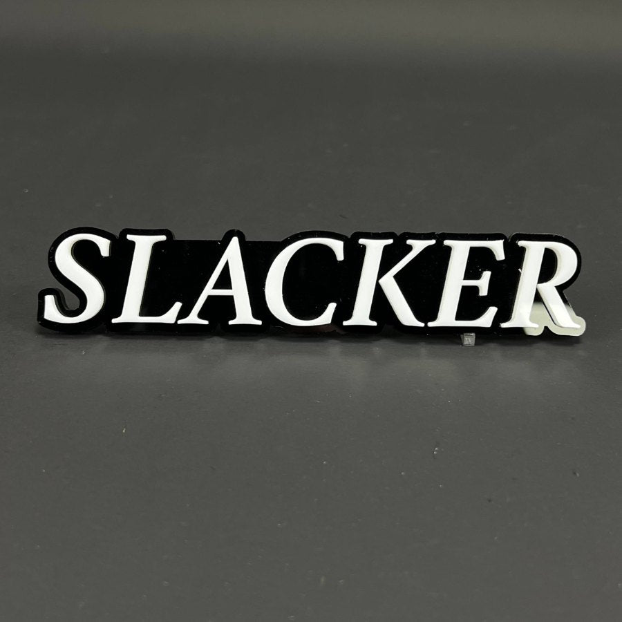 A custom 3D acrylic badge with raised lettering on a cut backing plate