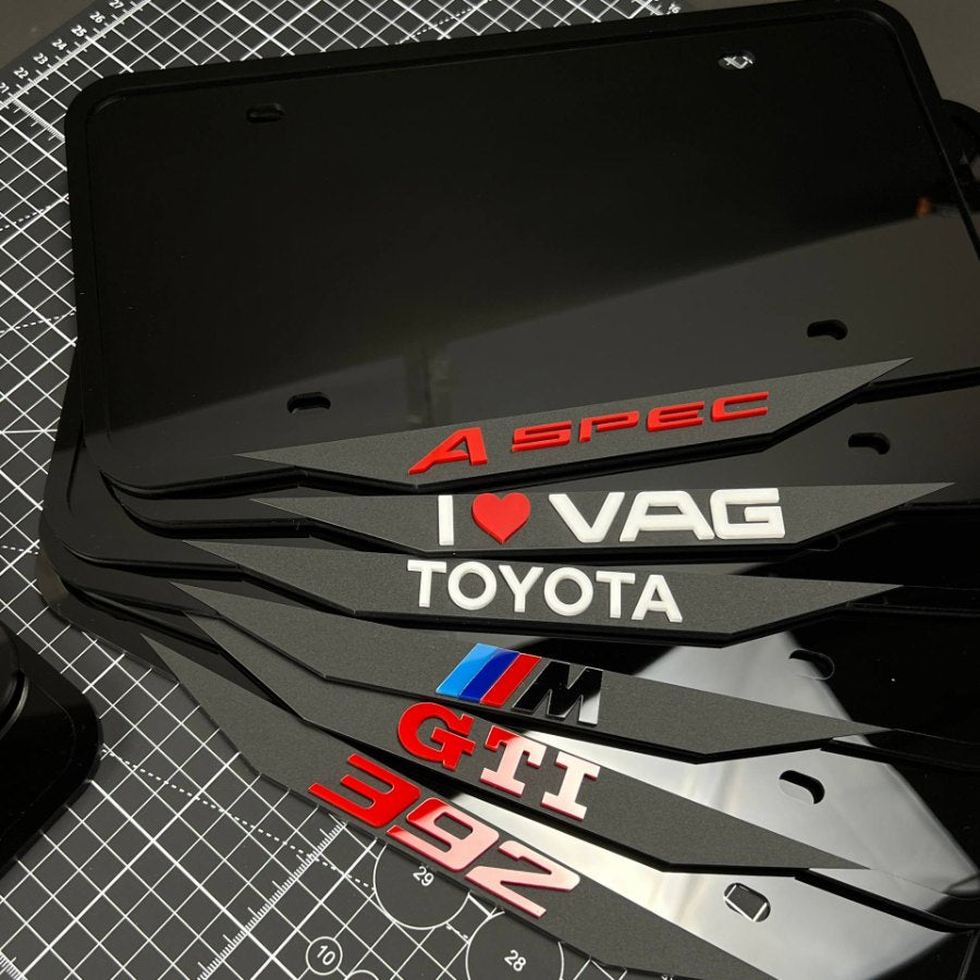 Forty finished logo plate frames from a single production day